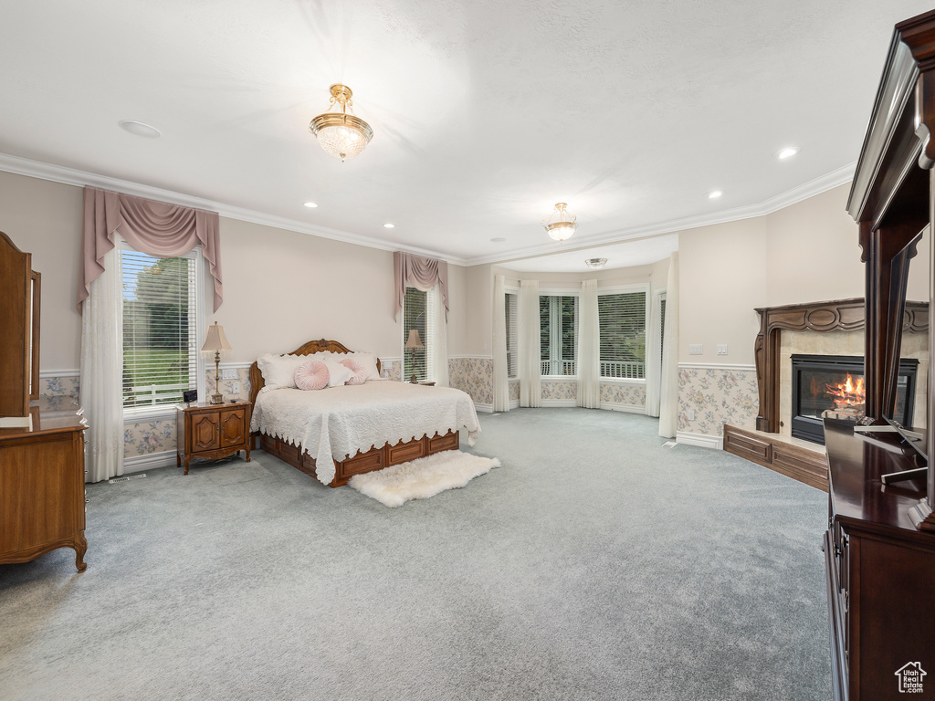 Bedroom featuring access to outside, crown molding, and light colored carpet