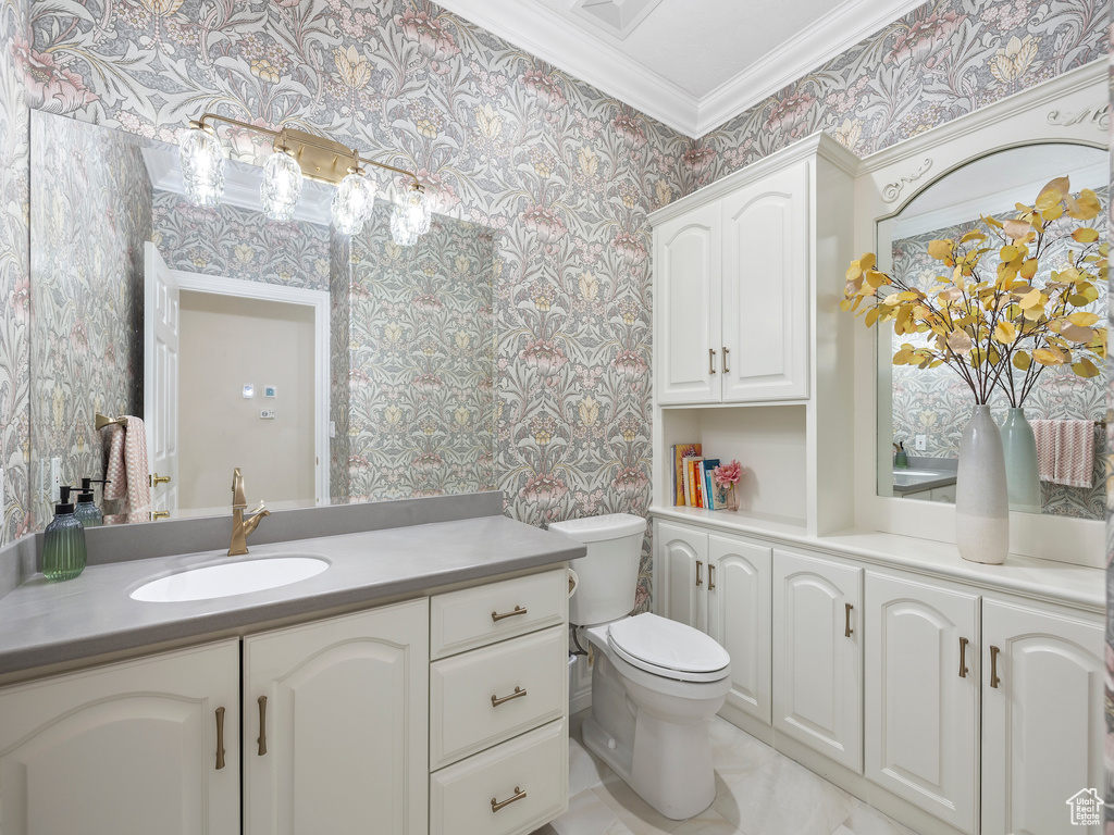 Bathroom featuring vanity, tile flooring, ornamental molding, and toilet