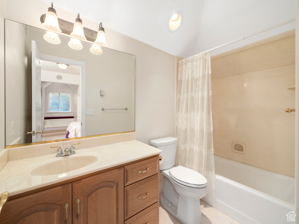 Full bathroom with large vanity, tile floors, shower / bathtub combination with curtain, and toilet