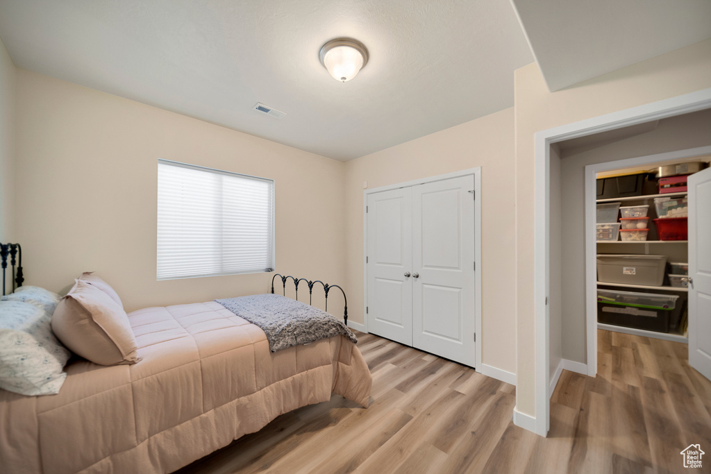 Bedroom featuring light hardwood / wood-style floors and a closet