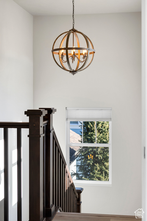 Stairs featuring an inviting chandelier