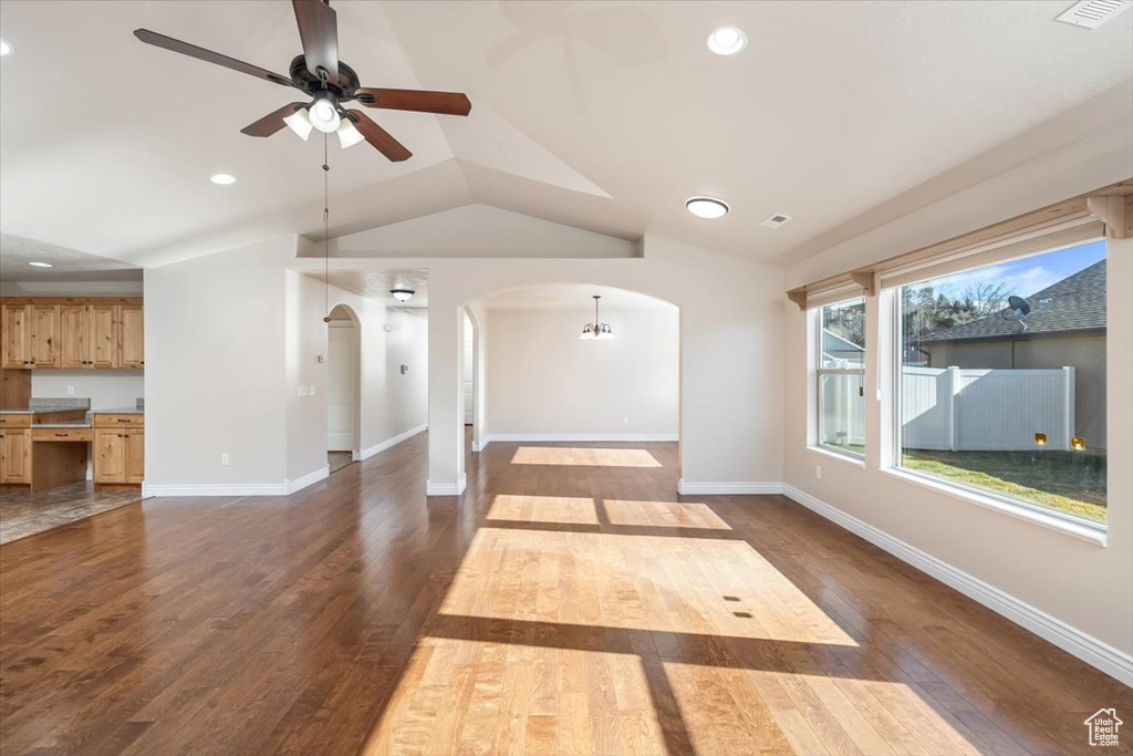 Unfurnished living room with hardwood / wood-style floors, ceiling fan, and lofted ceiling