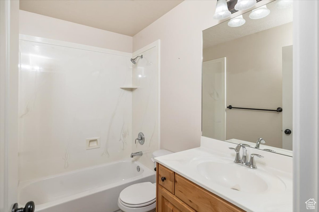 Full bathroom with bathing tub / shower combination, toilet, and vanity