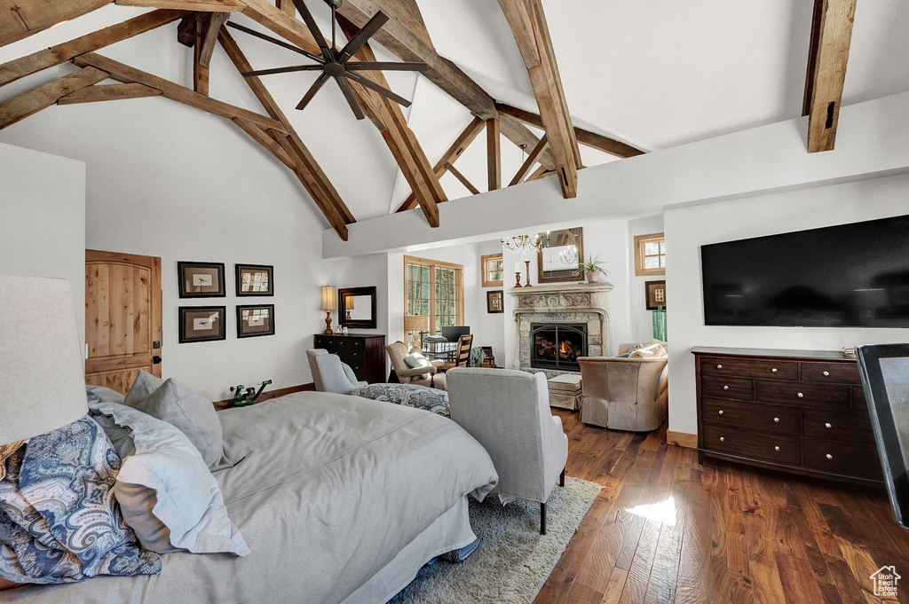 Bedroom with dark wood-type flooring, high vaulted ceiling, and beam ceiling