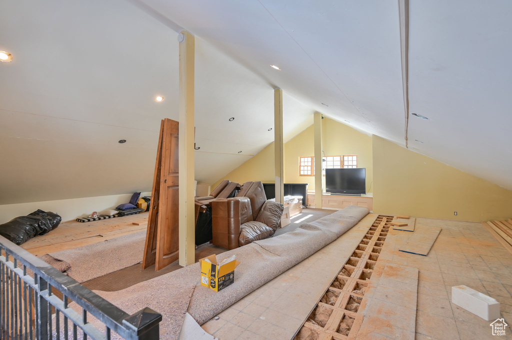 Interior space with vaulted ceiling and light tile floors