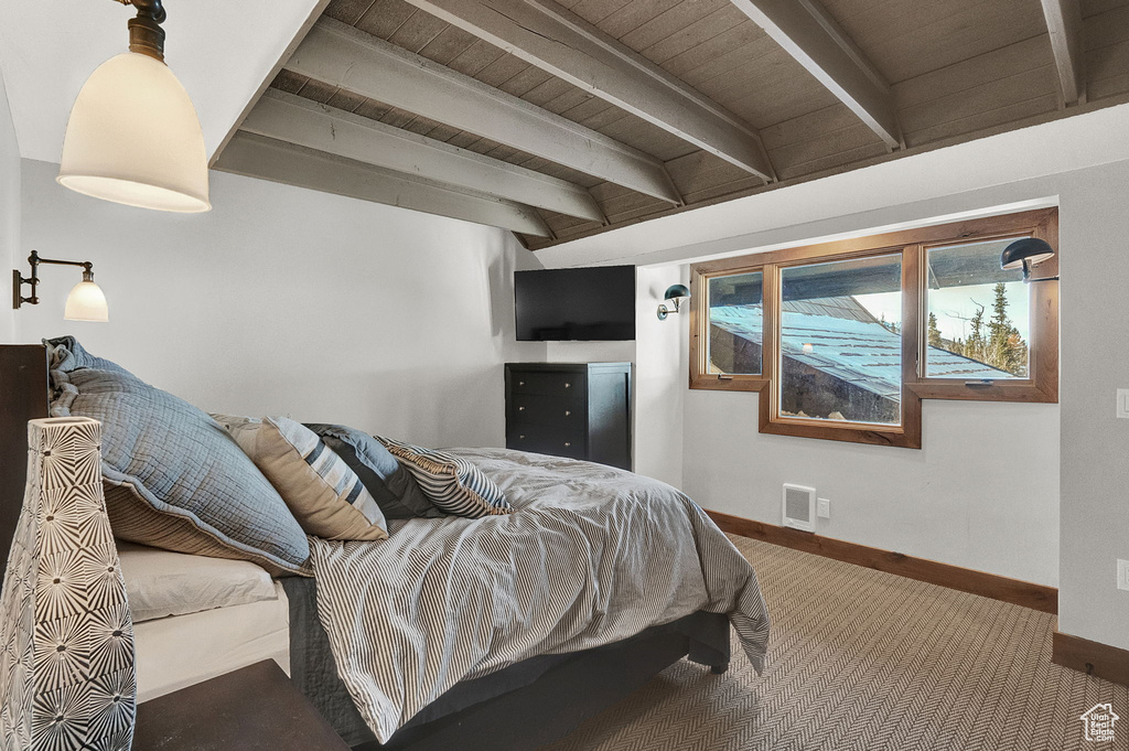 Carpeted bedroom featuring wooden ceiling and beamed ceiling