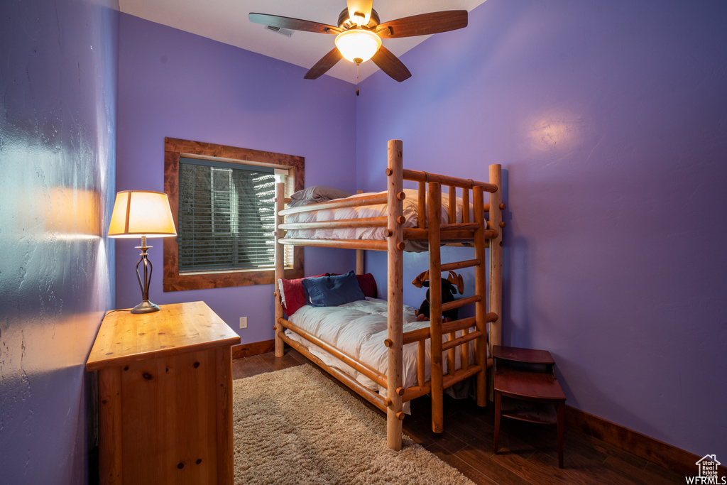 Bedroom featuring dark hardwood / wood-style floors and ceiling fan