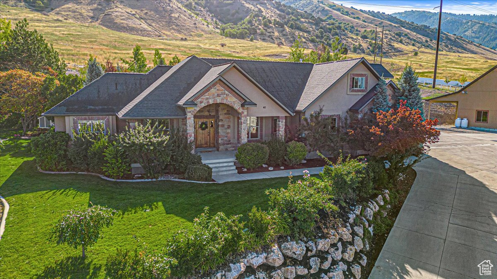 View of front of property with a front lawn and a mountain view