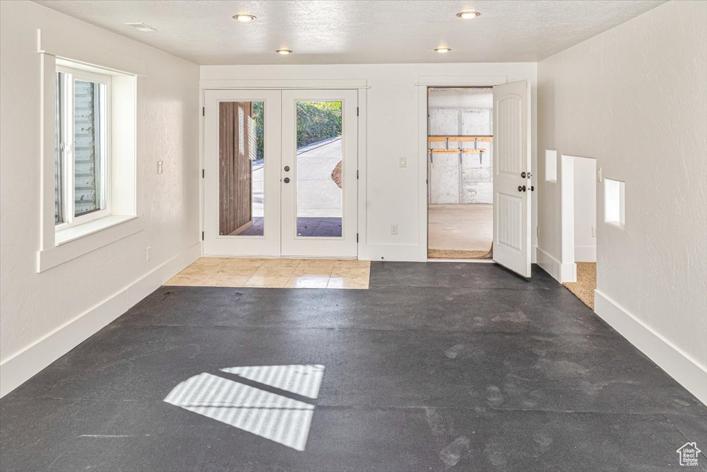 Interior space with french doors and a textured ceiling