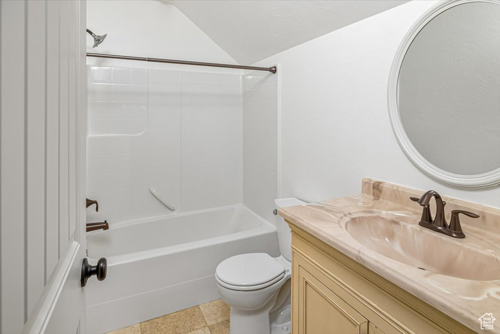 Full bathroom with tile flooring, shower / washtub combination, toilet, and vanity