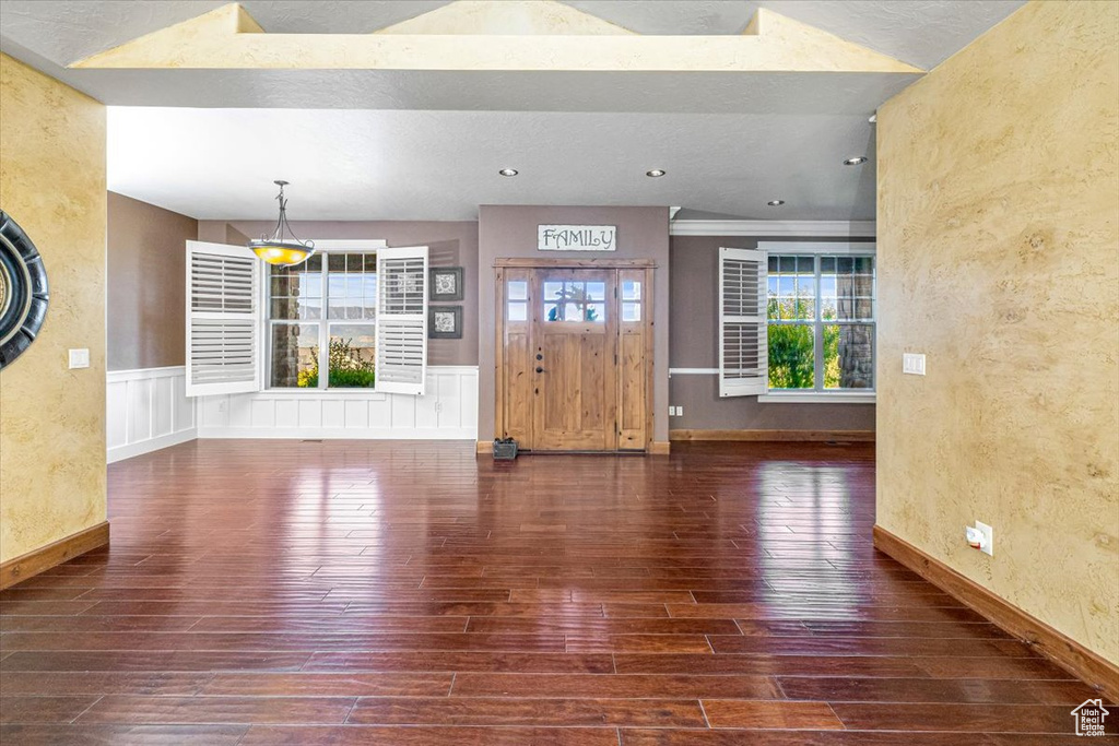 Unfurnished living room featuring dark wood-type flooring