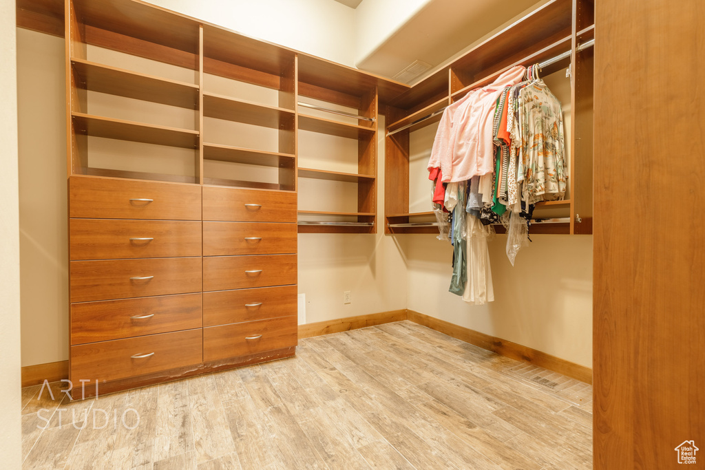 Walk in closet featuring light wood-type flooring