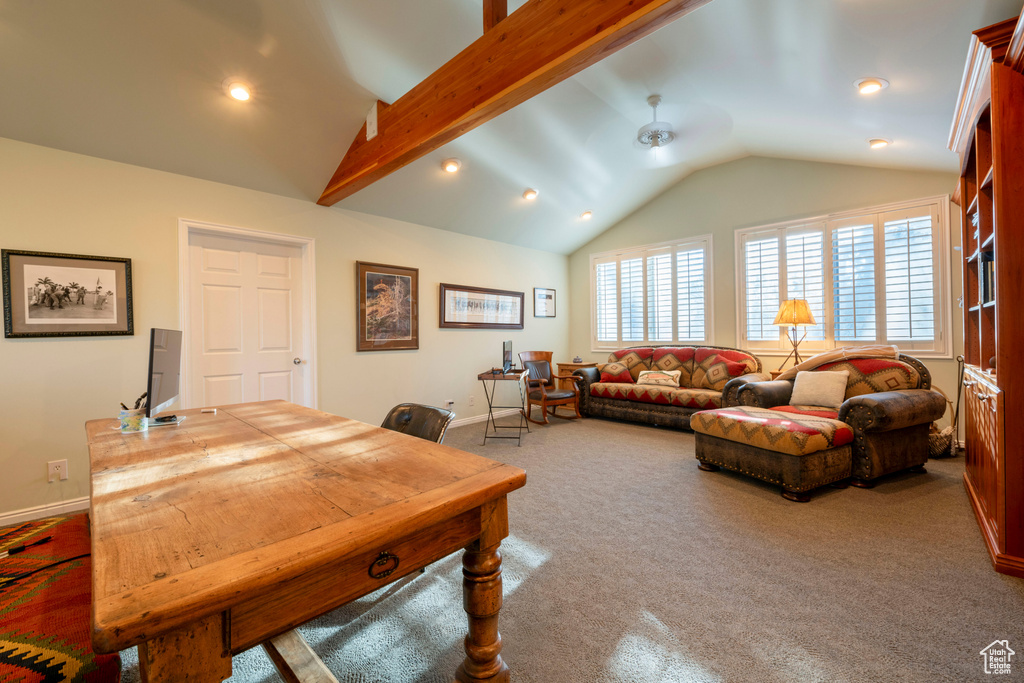 Living room with vaulted ceiling with beams, carpet floors, and ceiling fan