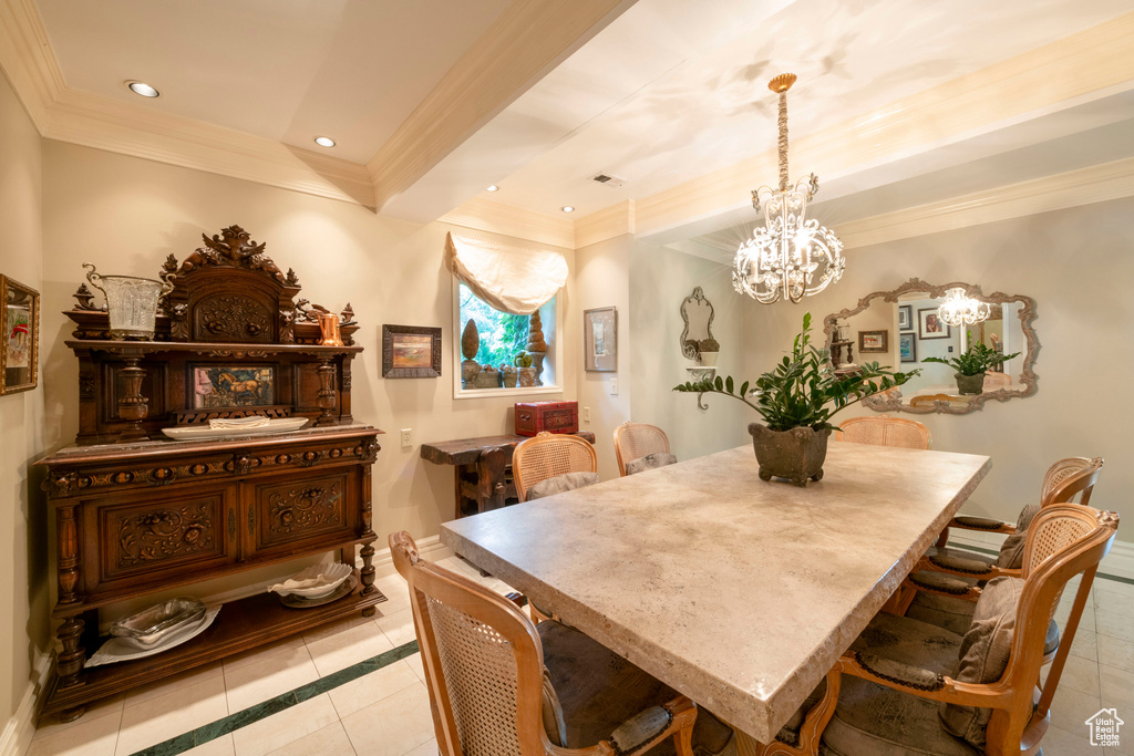 Dining space featuring light tile flooring, crown molding, and a notable chandelier