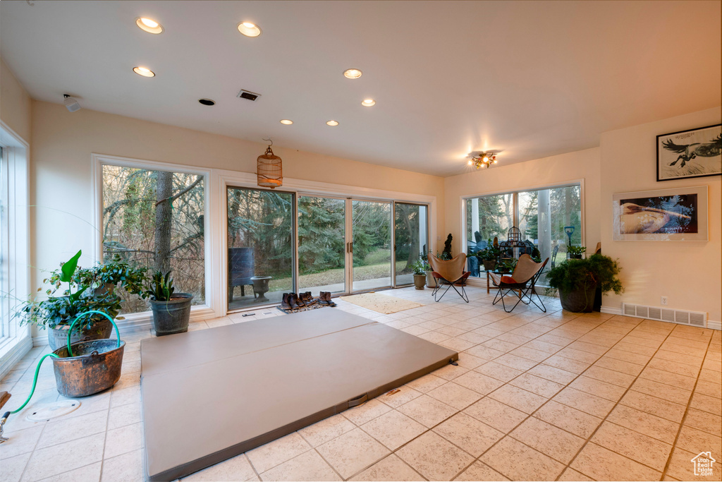 Living room with a wealth of natural light and light tile flooring