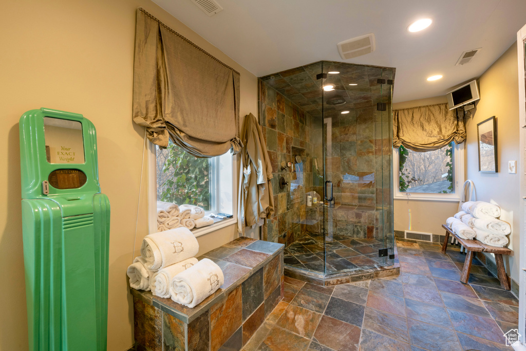Bathroom featuring walk in shower and tile floors