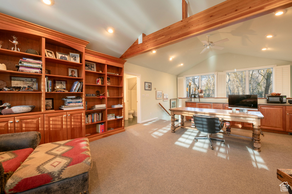 Office space with vaulted ceiling with beams, ceiling fan, and light colored carpet