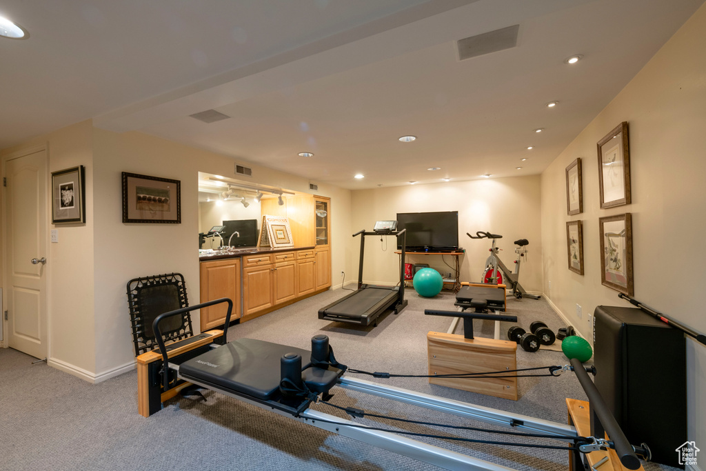 Exercise area featuring light colored carpet and sink