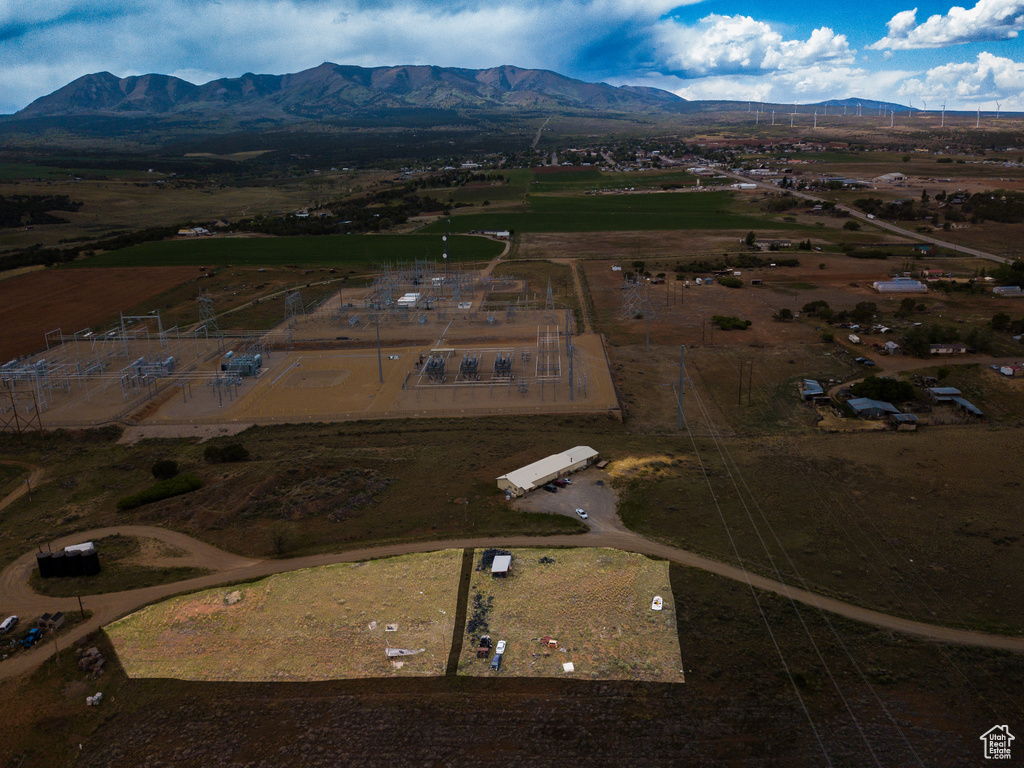 Aerial overview of property's location with a mountainous background and rural landscape