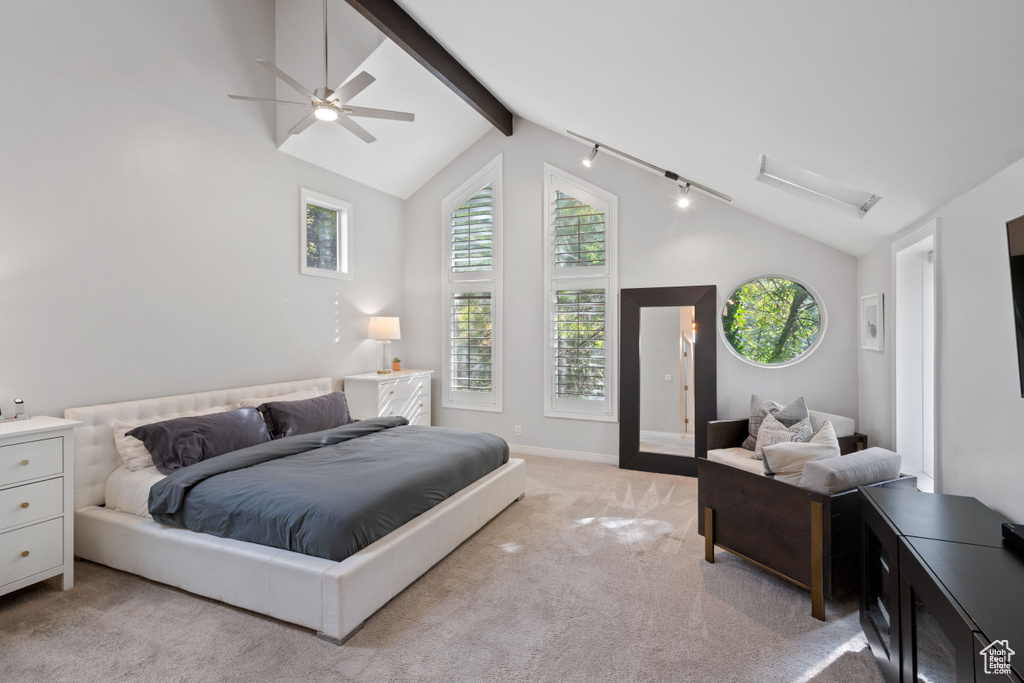 Carpeted bedroom featuring rail lighting, high vaulted ceiling, ceiling fan, and beam ceiling