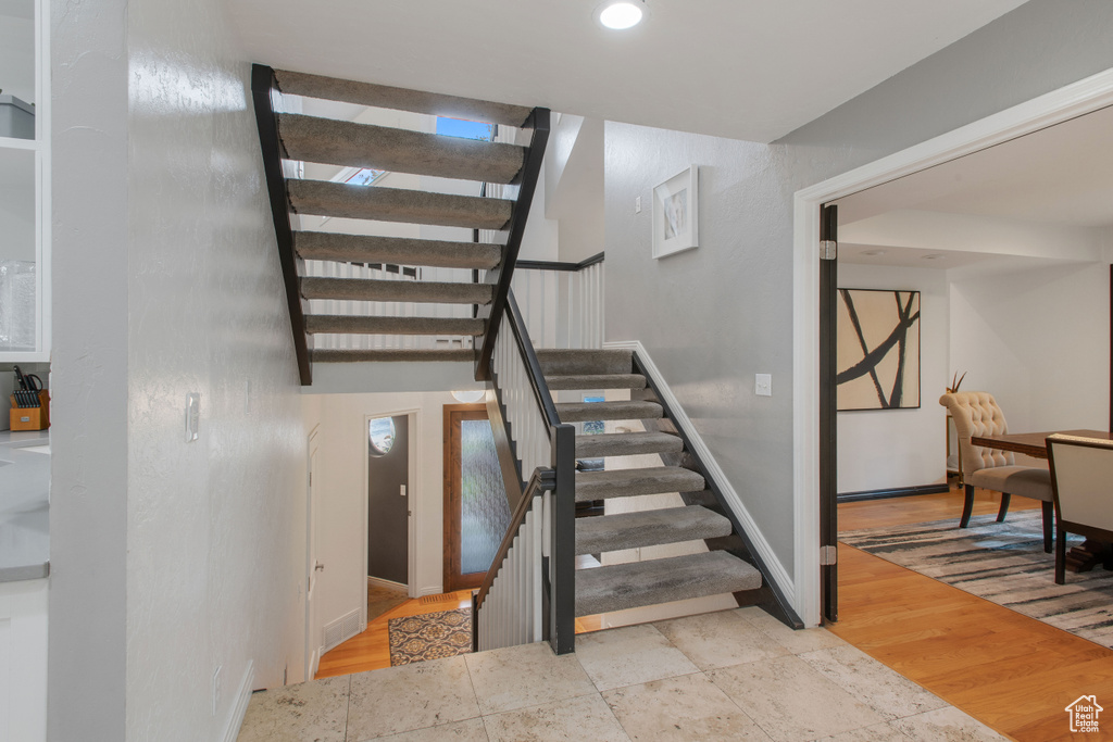 Stairs with light hardwood / wood-style floors