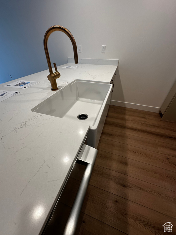 Details with dark hardwood / wood-style flooring and sink