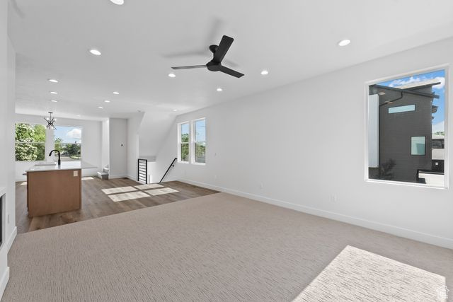 Living room with wood-type flooring, sink, plenty of natural light, and ceiling fan