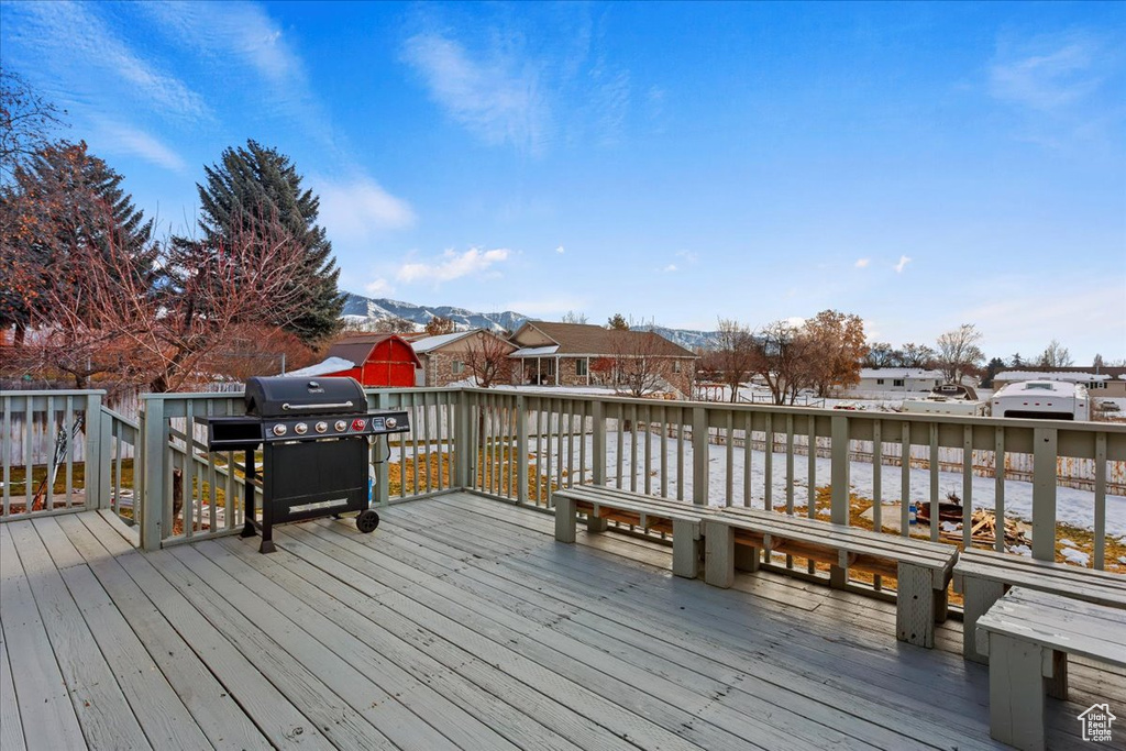 Wooden deck featuring a grill