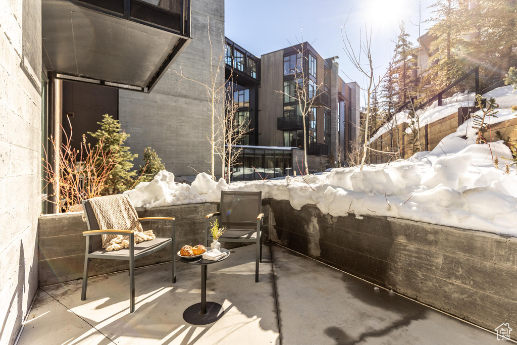 Snow covered patio featuring an outdoor hangout area
