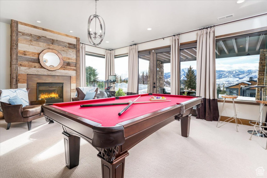 Game room featuring an inviting chandelier, pool table, and light carpet