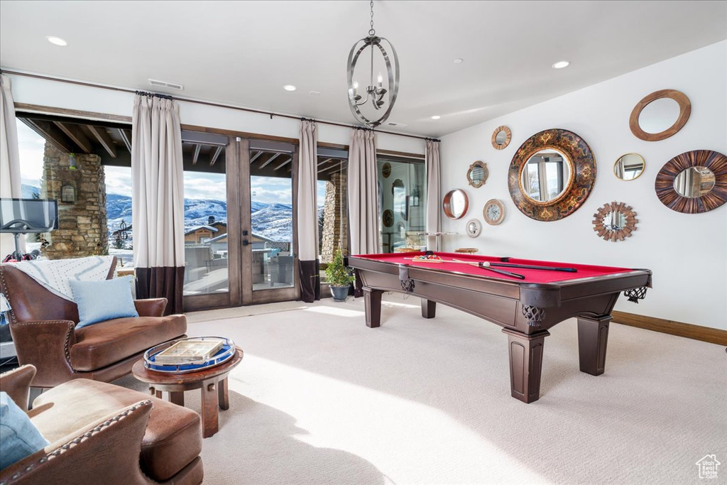 Recreation room featuring pool table, a chandelier, and light colored carpet