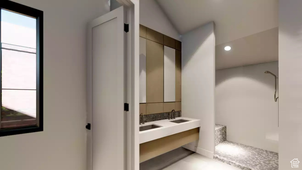Bathroom with sink, lofted ceiling, and walk in shower