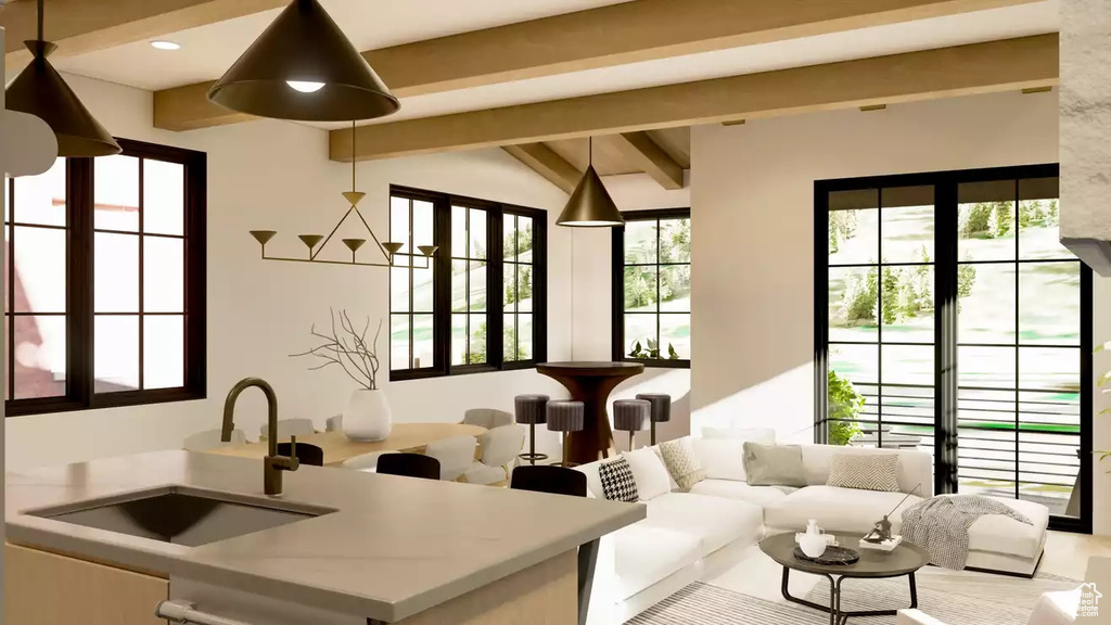 Living room with plenty of natural light, sink, and lofted ceiling with beams