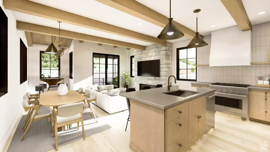 Kitchen with a fireplace, backsplash, decorative light fixtures, sink, and stainless steel stove