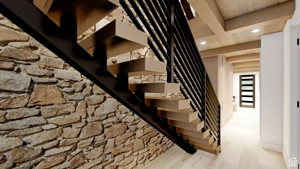 Staircase featuring light hardwood / wood-style flooring