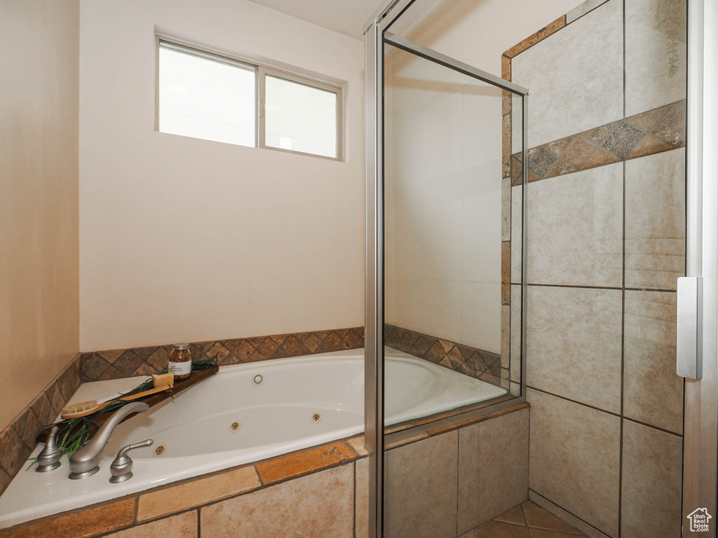 Bathroom featuring tile floors and plus walk in shower