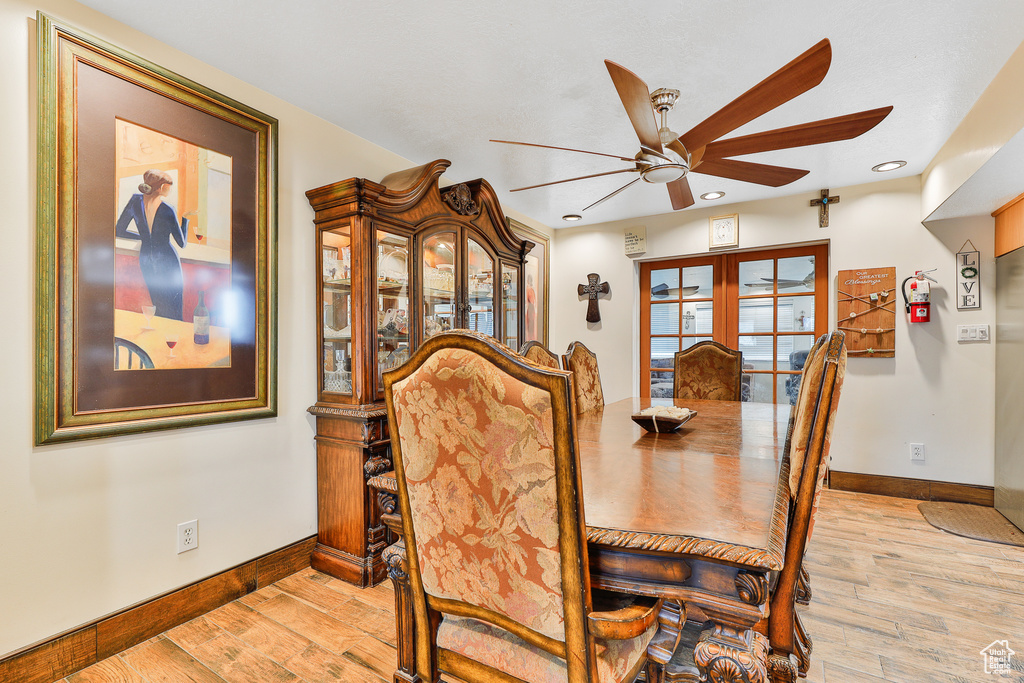 Dining space featuring french doors, light hardwood / wood-style floors, and ceiling fan