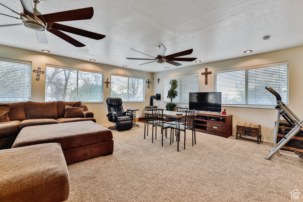 Living room featuring light colored carpet and ceiling fan
