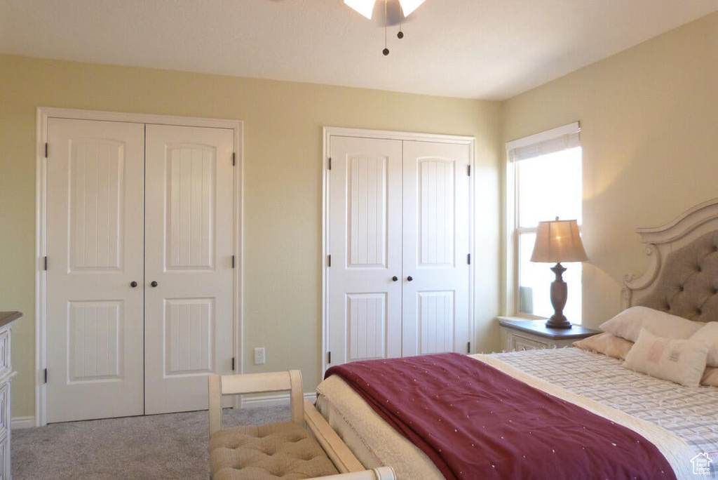 Bedroom featuring multiple closets and carpet