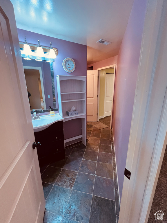 Bathroom featuring vanity and tile flooring