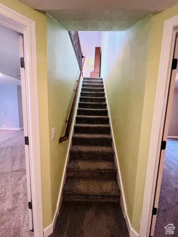 Stairway with light colored carpet