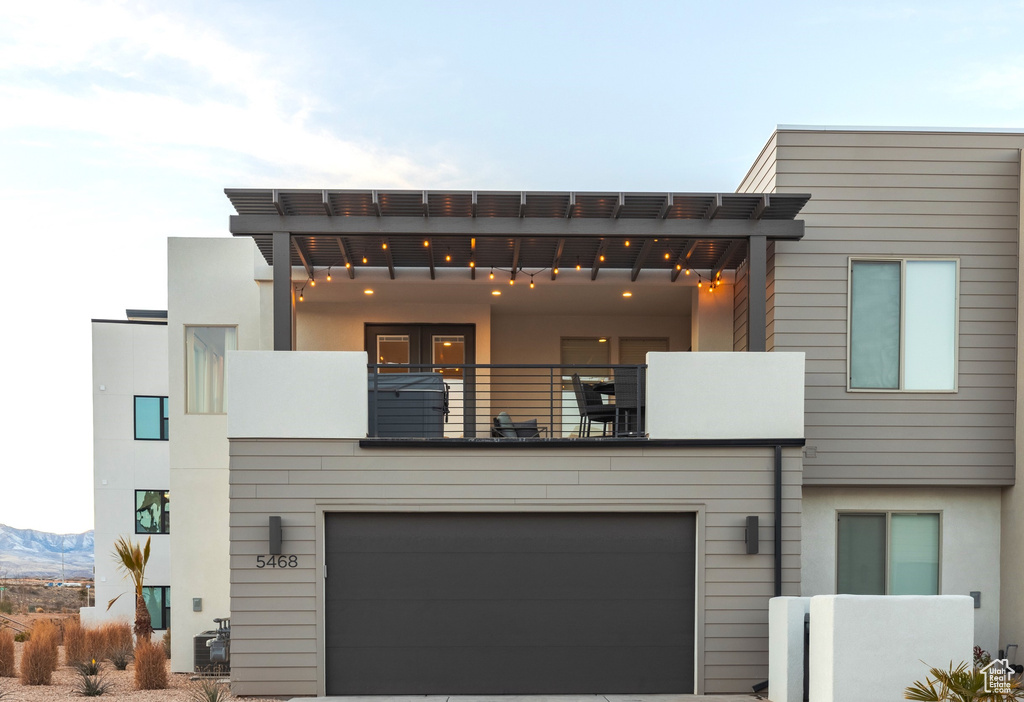 Contemporary home featuring a garage and a balcony