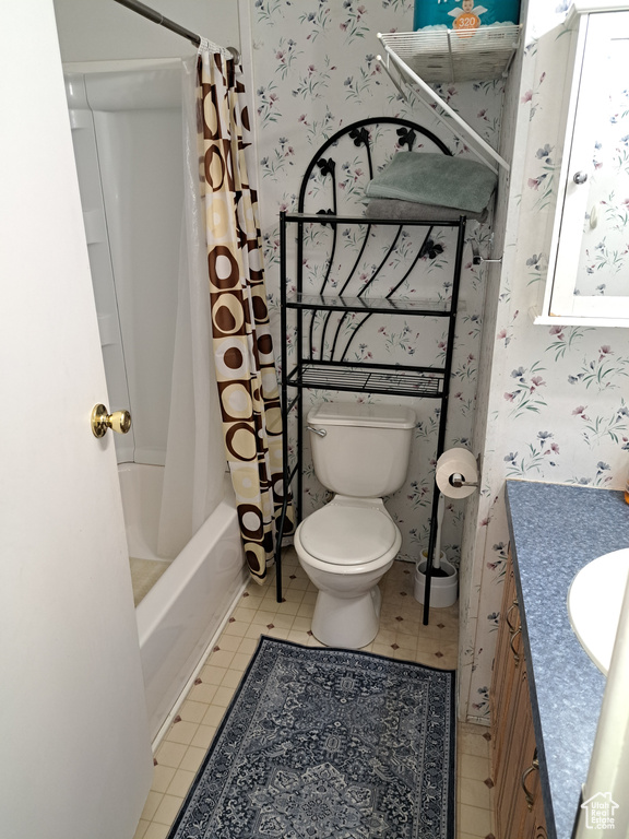 Full bathroom featuring vanity, toilet, shower / bath combination with curtain, and tile floors