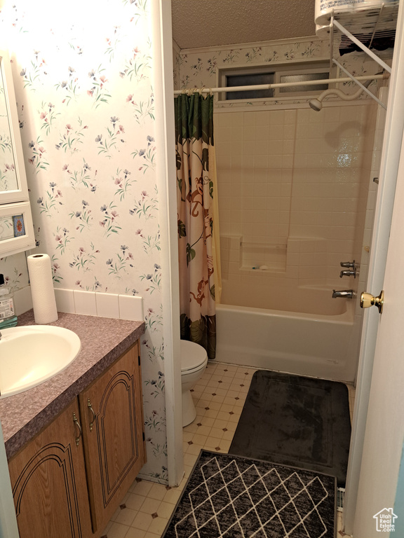 Full bathroom featuring vanity, toilet, shower / tub combo with curtain, and tile flooring