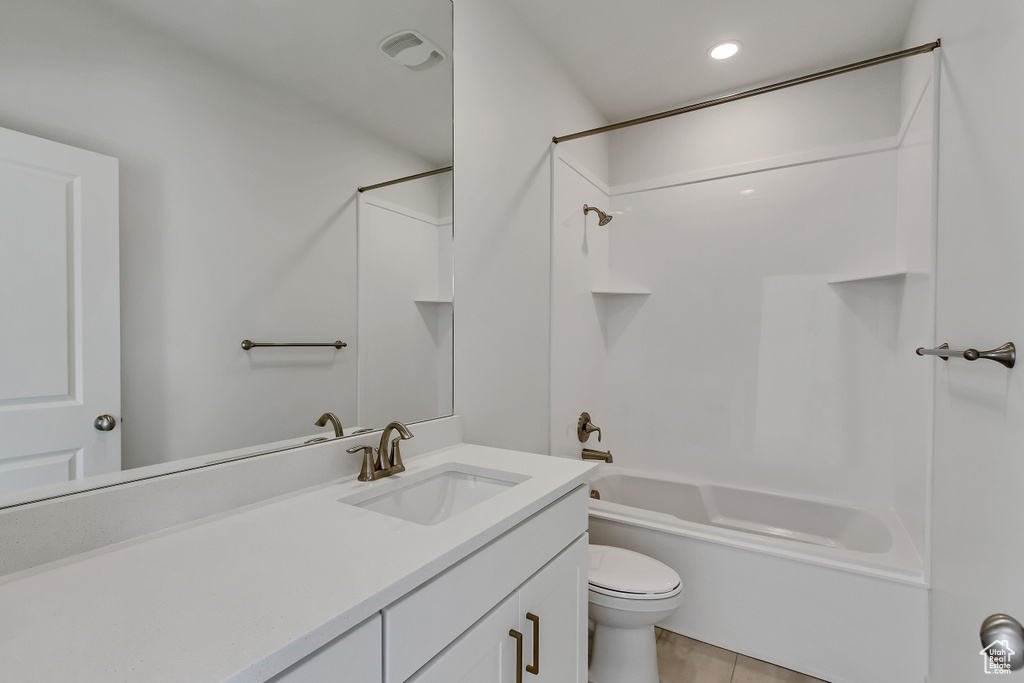 Full bathroom with toilet, shower / tub combination, oversized vanity, and tile flooring