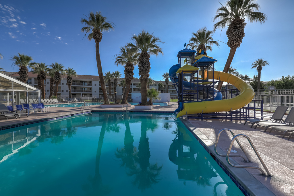 View of swimming pool featuring a water slide