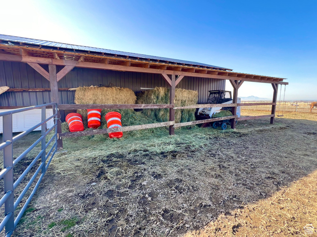 View of horse barn with a rural view