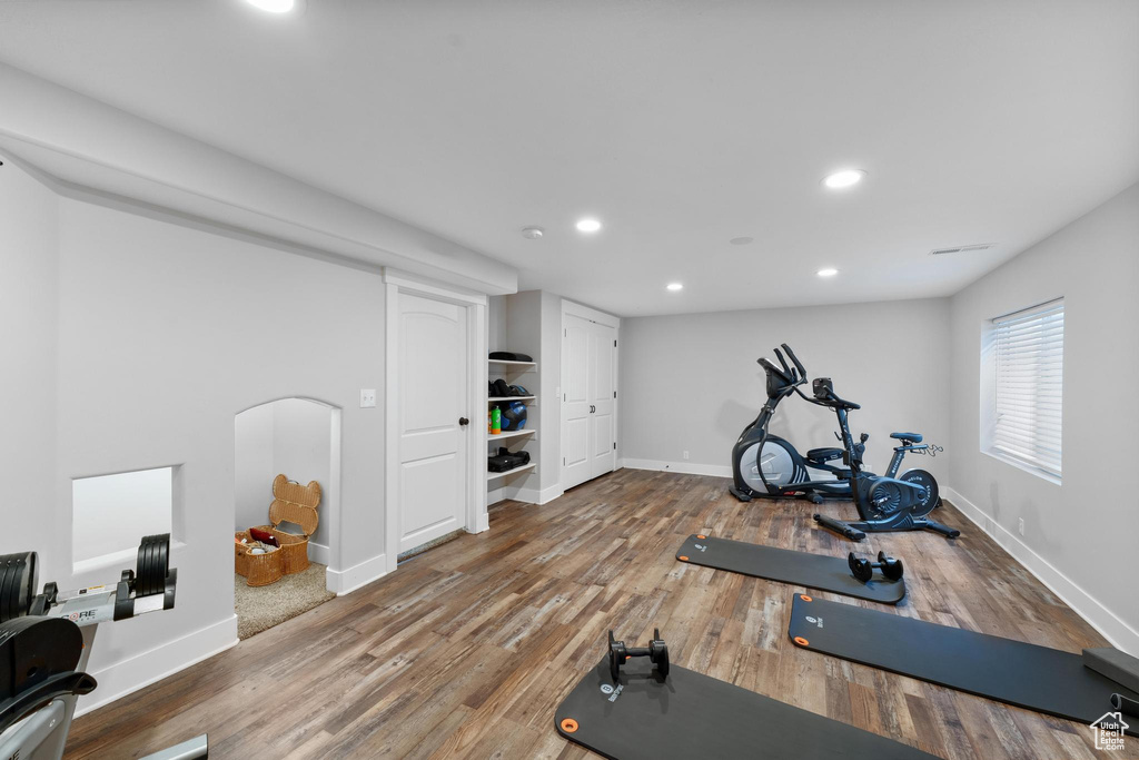 Exercise area with hardwood / wood-style floors