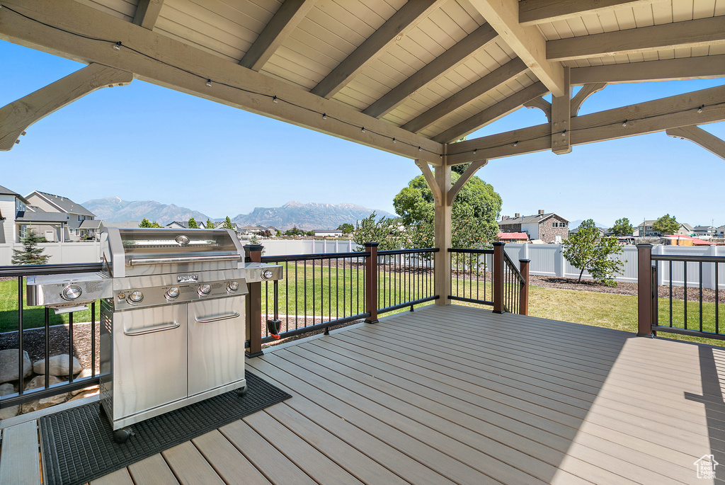 Wooden deck with a lawn, area for grilling, and a mountain view