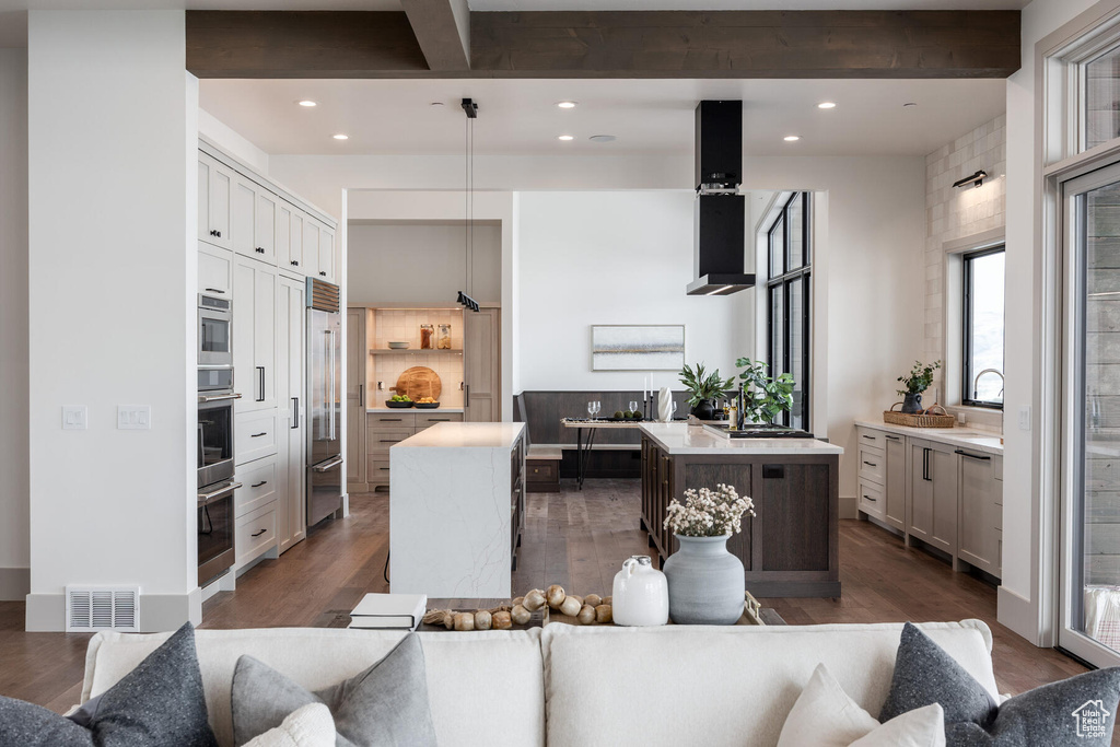 Kitchen featuring hanging light fixtures, dark hardwood / wood-style flooring, and a center island